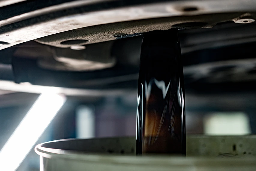Dark completion fluid sample being poured into a container