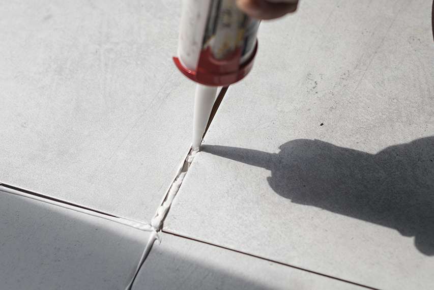 Grout being applied into tile joints with HEMC support