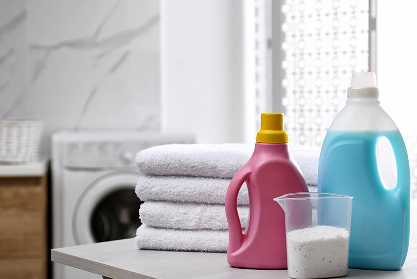 Laundry and dish detergent bottles in a household cleaning setting